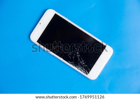 Broken mobile phone. Cracked smartphone screen