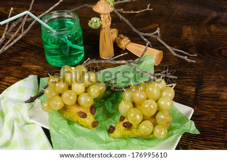 A healthy kid dessert, grapes and pears in the shape of a porcupine