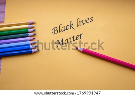 Many different colored pencils on yellow paper with the words, Black lives matter for stop racism concept, justice background colorful