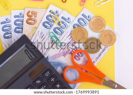 Colorful school supplies on white surface with calculator and Turkish money.Conceptual image of school expenses