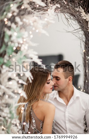 Christmas couple in a rural wooden house. Happy couple hugging. New Year Christmas love story, studio photo shoo.