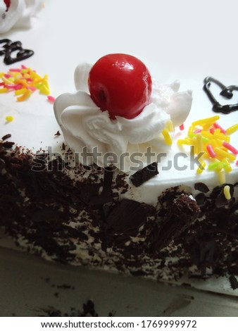 Berry isolated on the iced black forest cake 