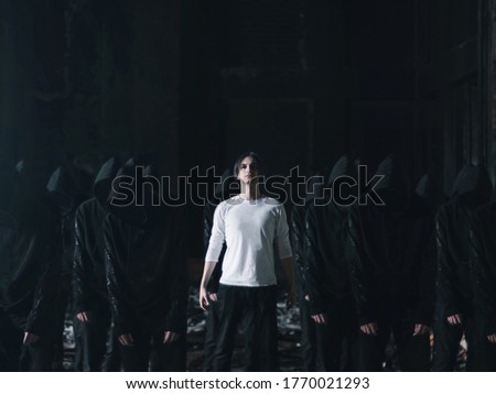 man in white with followers in black cult concept Royalty-Free Stock Photo #1770021293