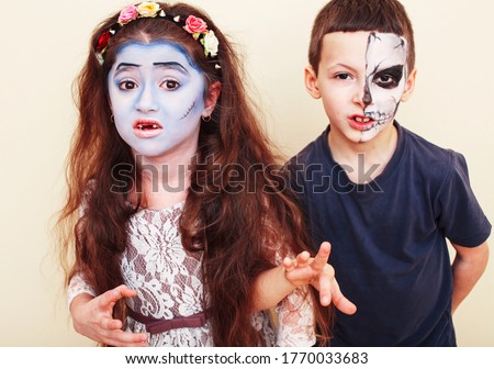 zombie apocalypse kids concept. Birthday party celebration facepaint on children dead bride, scar face, zombie skeleton together closeup makeup emotional posing.