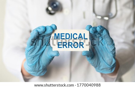 Doctor holding a card with medical error sign