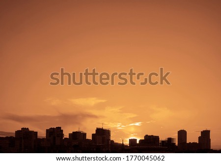 sunset sky in the city. Silhouette photo of residentia houses in the city at sunset.  down in the urban. Chelyabinsk, Russia.