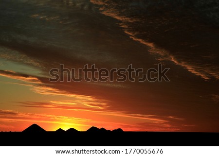 Sunset behind pyramids in Australia (opal mines)