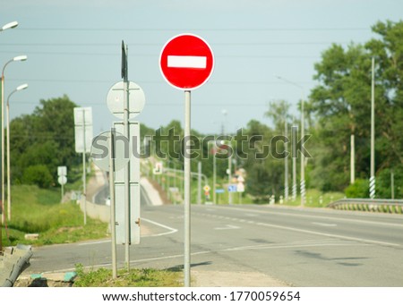 red stop sign on an empty highway on a summer day