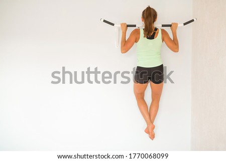 beautiful young woman goes in for sports at home