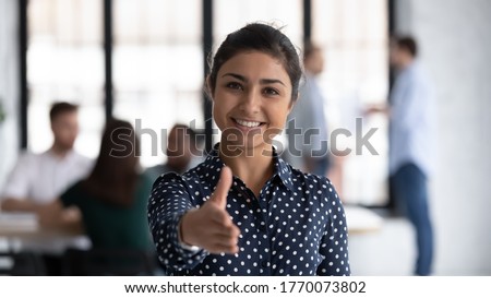 Head shot of friendly indian boss greeting client stretch out hand welcoming express amity good manners meet job vacancy applicant, first acquaintance, human resource HR manager recruiter work concept Royalty-Free Stock Photo #1770073802