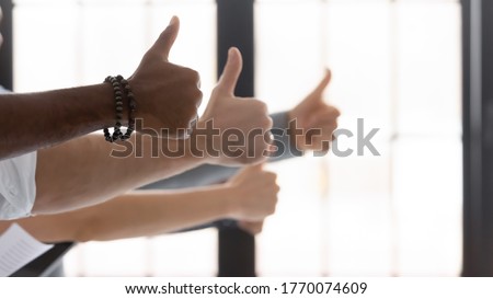 Hands of diverse people show thumbs up gesture close up. Satisfied multiracial clients express positive feedback of company services. Great offer. Successful teamwork results, racial equality concept Royalty-Free Stock Photo #1770074609