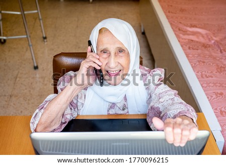 Old woman working from her home and making money after retirement