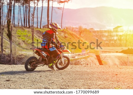 Close-up of biker sitting on motorcycle in starting point before the start of the race