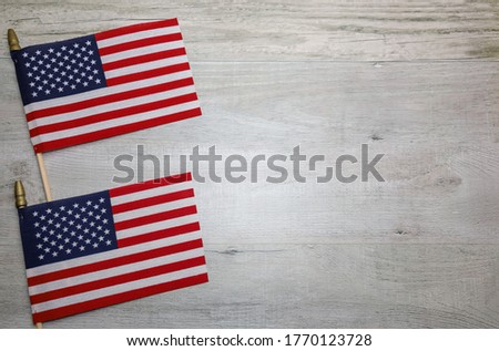 Two American Flags on a wooden background and copy space.