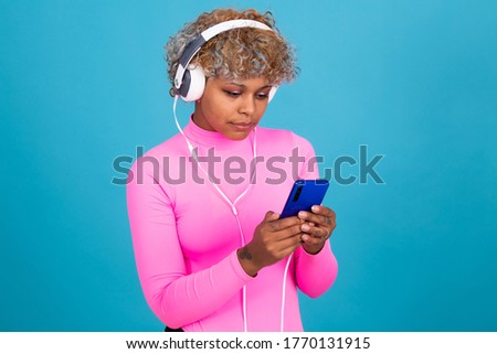 woman with mobile phone and headphones isolated on background