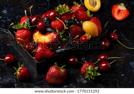 fresh berries on dark background in the box