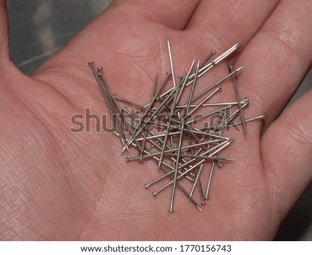 photography of pins in a hand