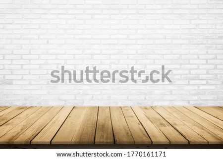 Empty wooden table top on white brick wall background, Design wood terrace white. Perspective for show space for your copy and branding. Can be used as product display montage. Vintage style concept.