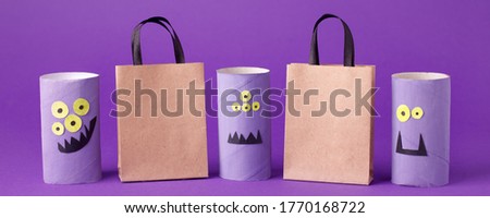 Autumn season Halloween holiday sale concept - toy from toilet roll tube, recycle idea and paper craft shopping bag on purple background, eco-friendly easy diy, flyer, coupon