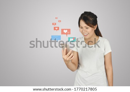 Young girl using smartphone with Social media,social network on grey background.