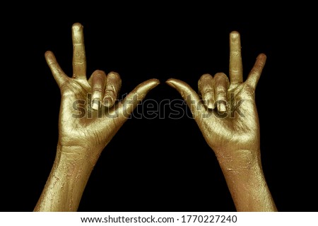 Golden hands on black background