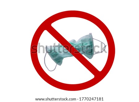 Used green surgical face mask in red forbidden symbol on white background. No discard used medical face mask in this area. Medical waste management with hygienic rule in hospital and community.