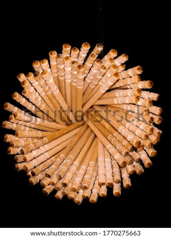 a creative photograph of toothpicks depicting a flower