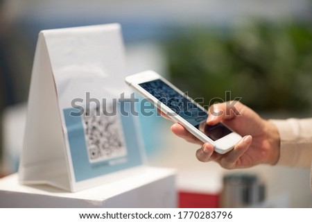 Asian woman And hold a mobile phone, scan the qr code for payment.New normal live social relaxation period.