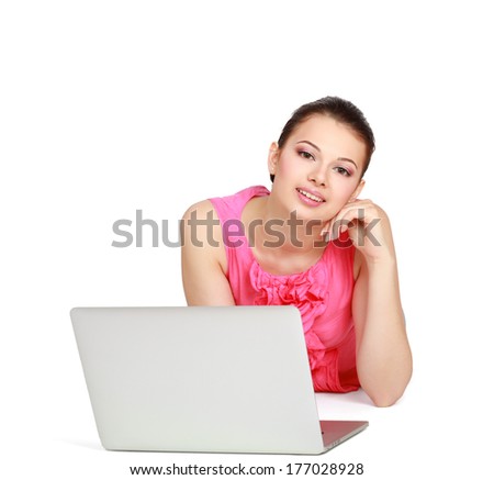 Portrait of beautiful young woman lying on floor with a laptop - isolated on white background