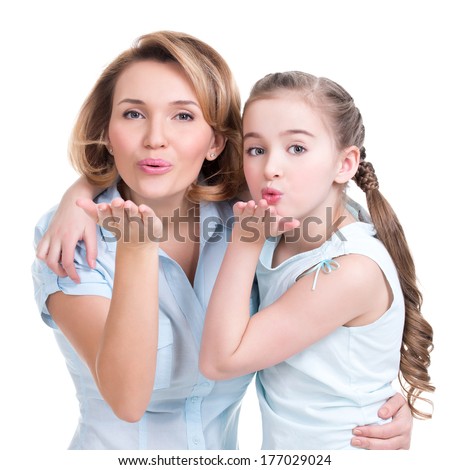 Portrait of mother and daughter send kisses - studio shot on white