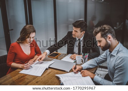 Legal consultation. A lawyer helping a couple to fill legal papers Royalty-Free Stock Photo #1770295967