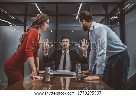 Hot argument. A lawyer trying to stop the argument between spouses Royalty-Free Stock Photo #1770295997