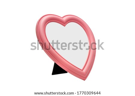 Pink color heart shaped desktop mirror isolated on white background.