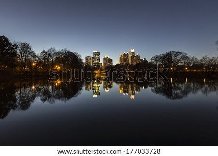 Midtown Atlanta night reflected in the lake at popular Piedmont Park.