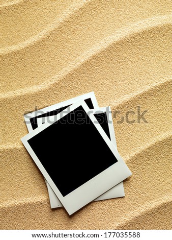Summer like vintage style empty photo cards lying on a sea sand. Sunny summer background. Space for your text.  