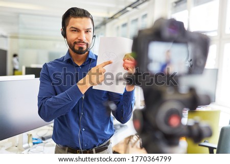 Businessman with headset and document recording instructional video for a workshop online Royalty-Free Stock Photo #1770364799