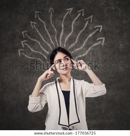 Businesswoman thinking with many arrows above her head