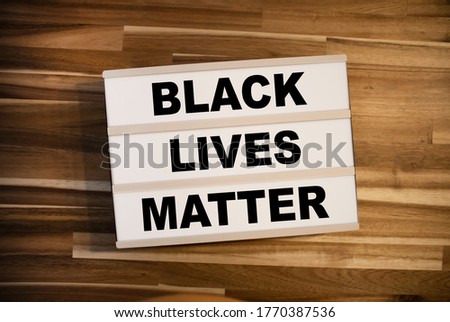 Light box or lightbox with message Black Lives Matter on a wooden table background