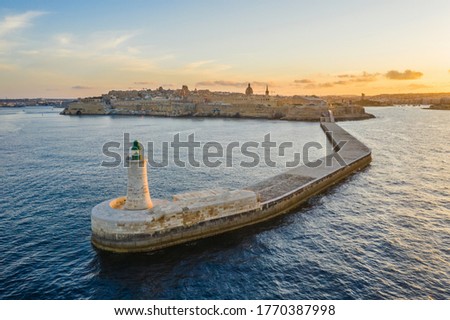 Aerial view of green lighthouse in Grand harbor. Valletta, Malta island. Sunset