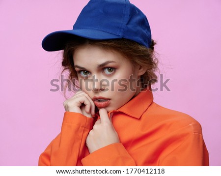 Beautiful woman blue cap orange coat luxury cosmetics elegant fashion style pink background