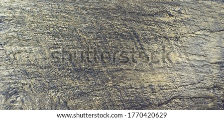 Golden background. Painted gold slate board texture. Shiny reflective stone plate surface