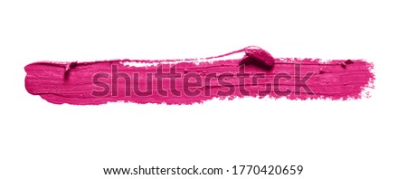 Pink lipstick stroke smudge swatch isolated on white background. Color makeup brush stroke close up. Creamy cosmetic product texture