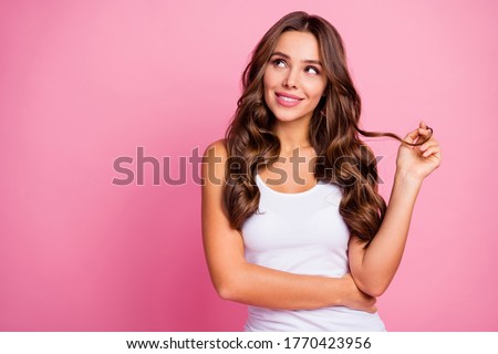 Photo of funny pretty wavy lady arm winding curl around finger wondered look up empty space dreamer wear white casual tank-top isolated bright pink color background