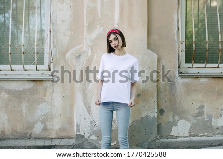 Woman or girl wearing white blank t-shirt with space for your logo, mock up or design in casual urban style