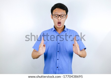 Young asian man is smile and excited with hand showing square hand in the middle like a box.