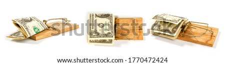 conceptual picture of a mousetrap with small dollar bills on a white background in several different positions