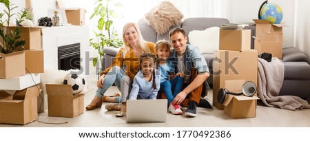 Portrait of nice attractive lovely charming cheerful big full family sitting mom dad making roof new apartment move