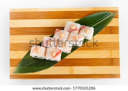 Maki Sushi Rolls set on wooden bamboo board. Japanese traditional Cuisine. White background. 