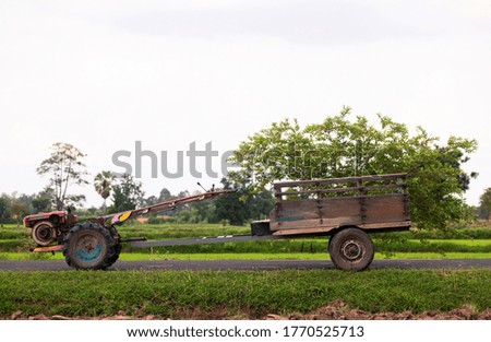 
Agricultural vehicles used in farming of Asian people park on the road.