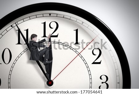 Deadline. Businessman trying to stop time. Time Management. Time pressure. Cure for old age. Annual reports. Front view. Royalty-Free Stock Photo #177054641